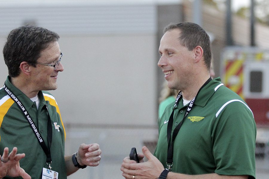 Jeff Bailey, principal, (on the right) talks with Dr. Bret Champion, Superintendent, at the football games vs. Oak Ridge.