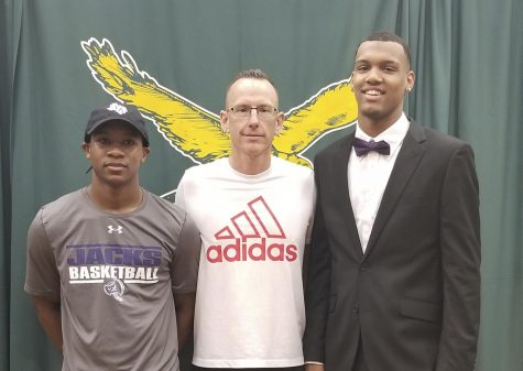 Kharee McDaniel and Calvin Solomon pose with KF basketball coach Cary Black after signing with Stephen F. Austin State University.