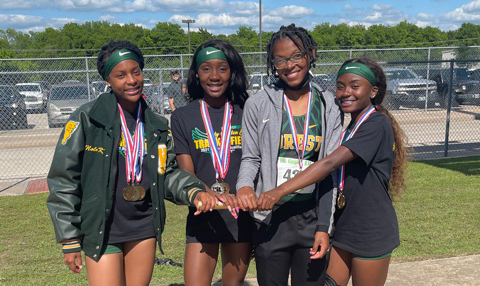 Kayla Meyers, Chelsea Heggar, Charnay Derrick, and ANiya Galloway take the baton to the State Meet.