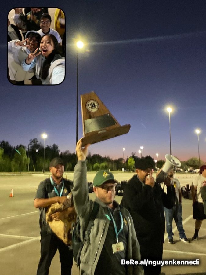 Kennedi Nguyen uses the social media app BeReal to capture the trophy after band earned sweepstakes at the UIL Region competition.