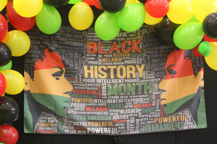 African American Heritage Society’s (AAHS) flag honoring Black History Month surrounded in a balloon arch.