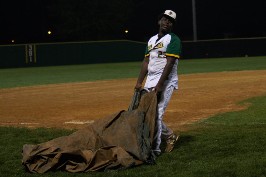 After the game ended, junior Beldon Smith carried the tarp over the pitchers mound. 
