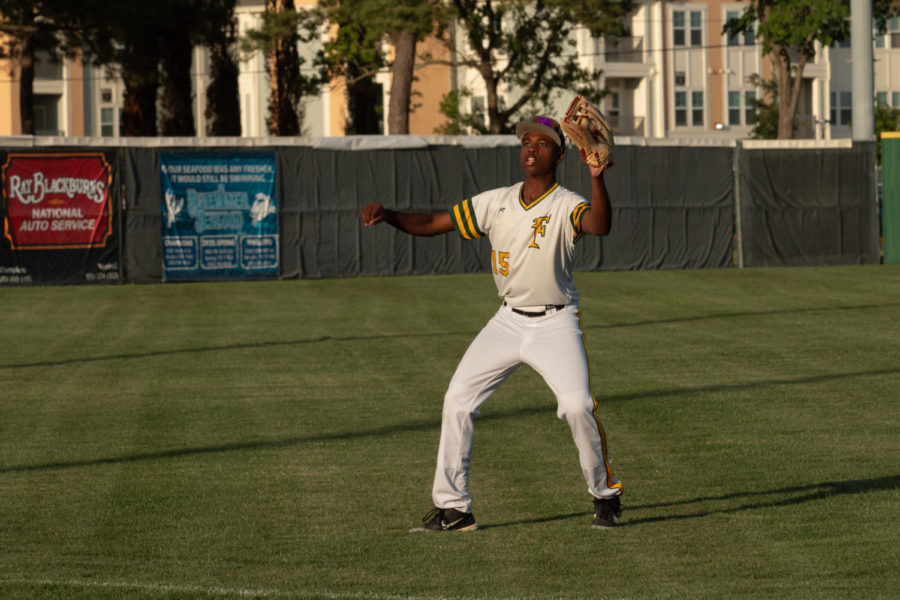 While practicing, freshman Jaylen Ross eyes the ball in the air while having his glove ready for a clean catch.  