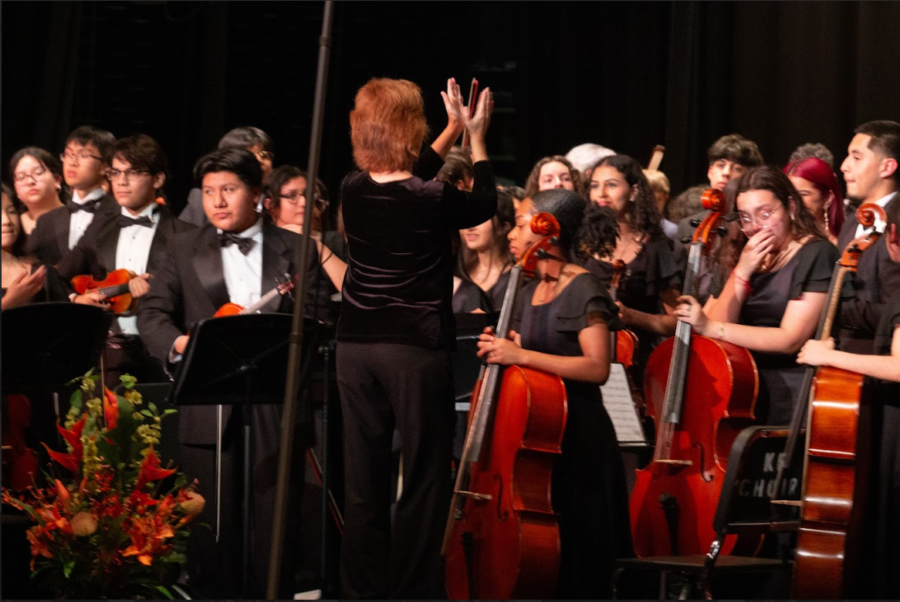 Mamie Morlacci claps her hands together towards the all-combined orchestra to applaud everyone for their performances on this night. 