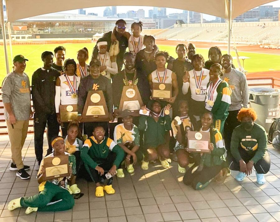 The boys and girls track and field team along with coaches poses together with their newly-won plaques, trophies, and medals from the state competition in Austin. 