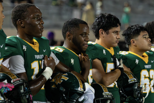 Seniors Justin Flemmings, Rayshaun Aubrey, Joshua Moran and junior Carlos Matic await for the game to start as the national anthem plays. 