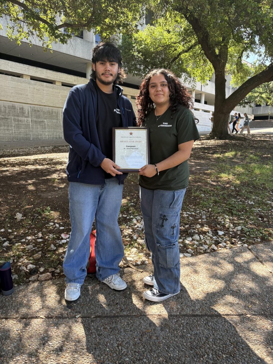 Christopher Alvarez and Savannah Villareal pose to take an editor picture with the Bronze Star Award at the ILPC Spring Convention.